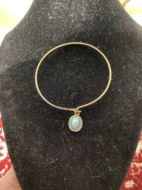 Gold Tone Bangle Bracelet with Blue Oval Charm